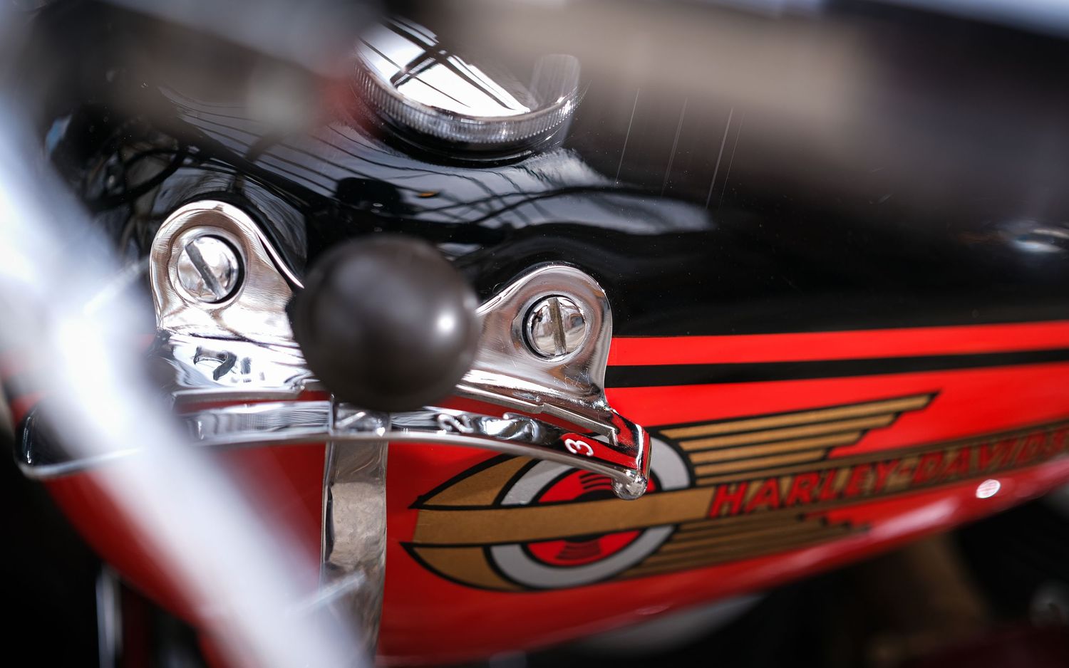 Close-up detail shots of vintage motorcycle parts showcasing chrome and red paint details.