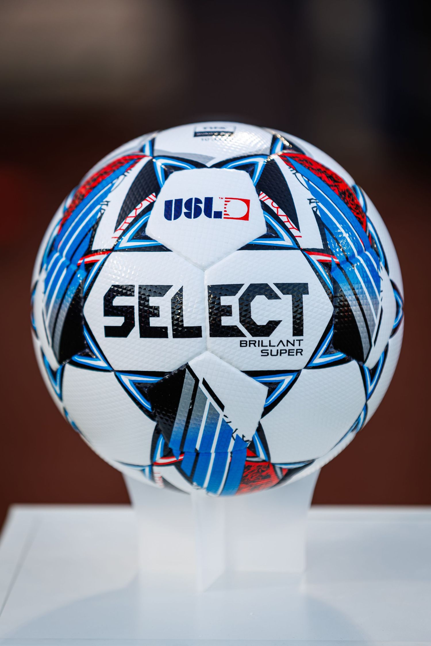 Official USL Select branded soccer ball with blue and red geometric design pattern on white background.