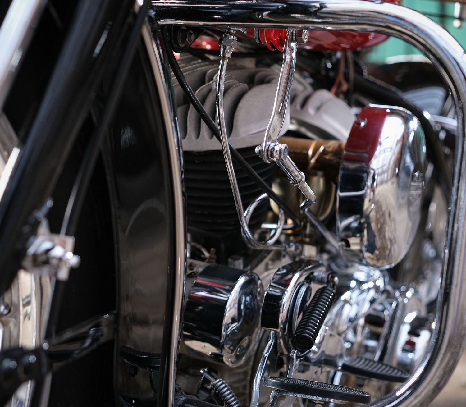 Detailed view of motorcycle engine components with chrome and black metal parts.