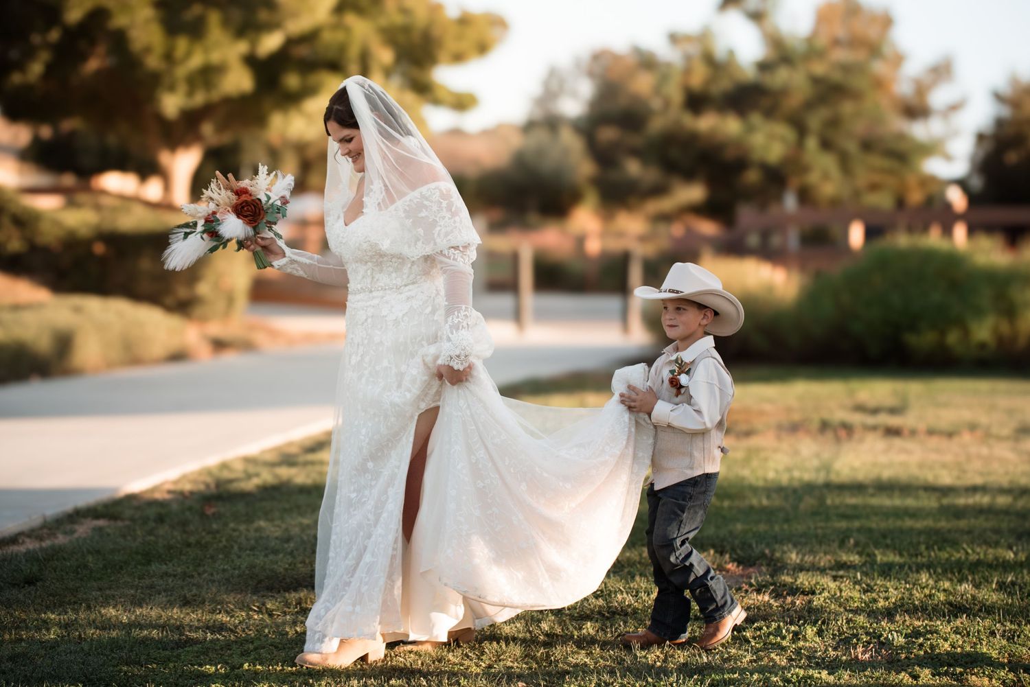 A playful moment captured on a grassy hill during a sunset photo session.