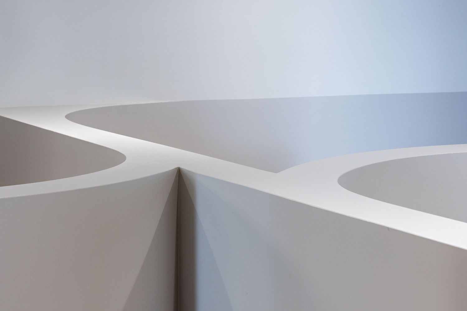 Abstract white architectural detail showing curved geometric shapes and clean lines.