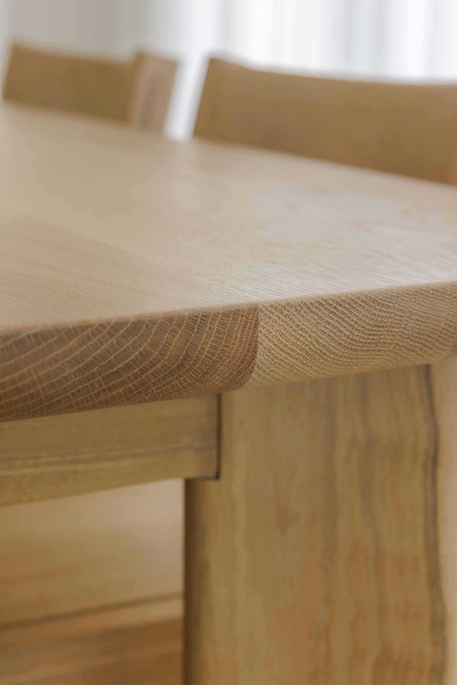 Close-up macro shot of natural wood grain texture on a table surface showing detailed patterns and lines.