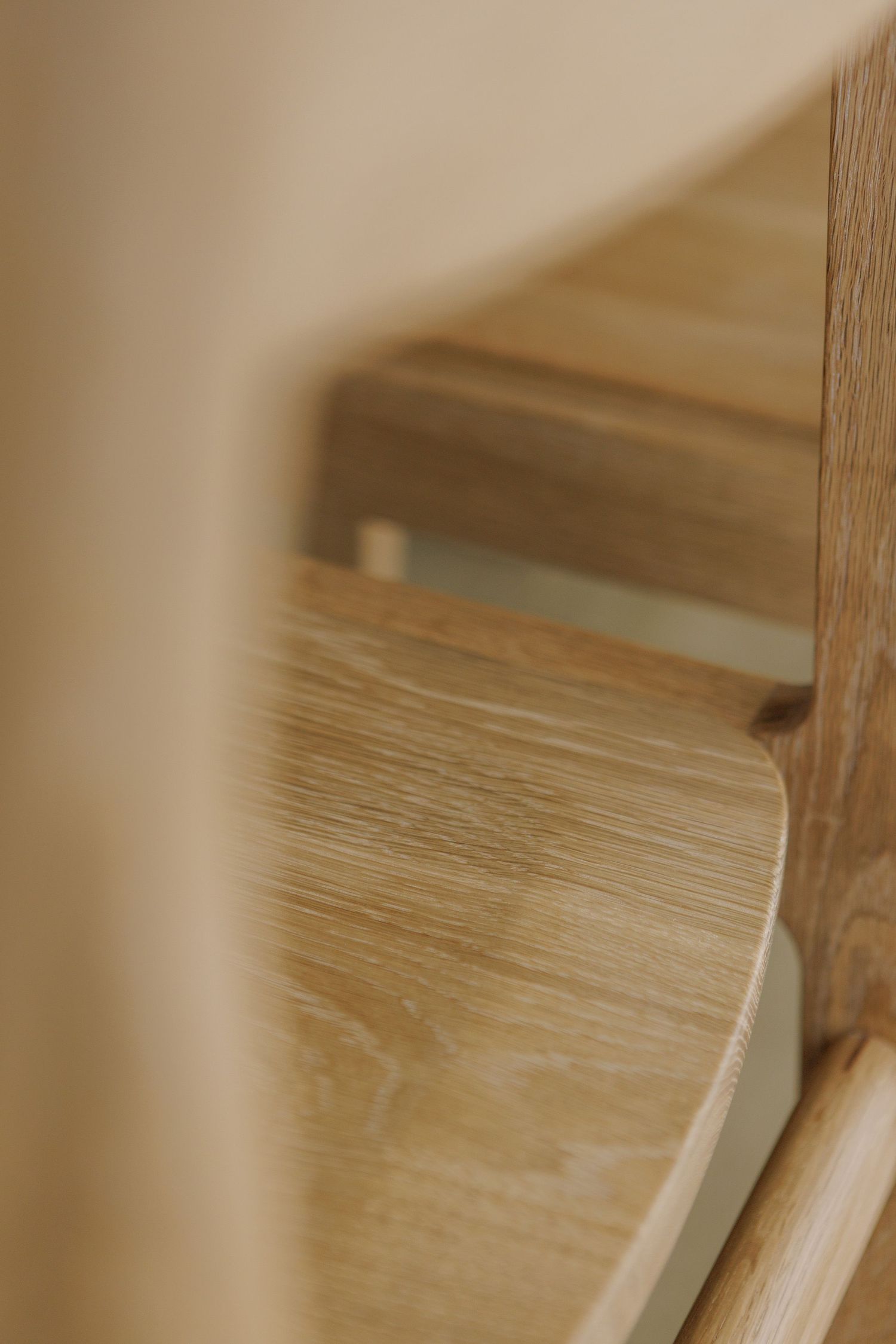 Close-up view of wooden shelves showing natural grain texture and clean lines in warm lighting.