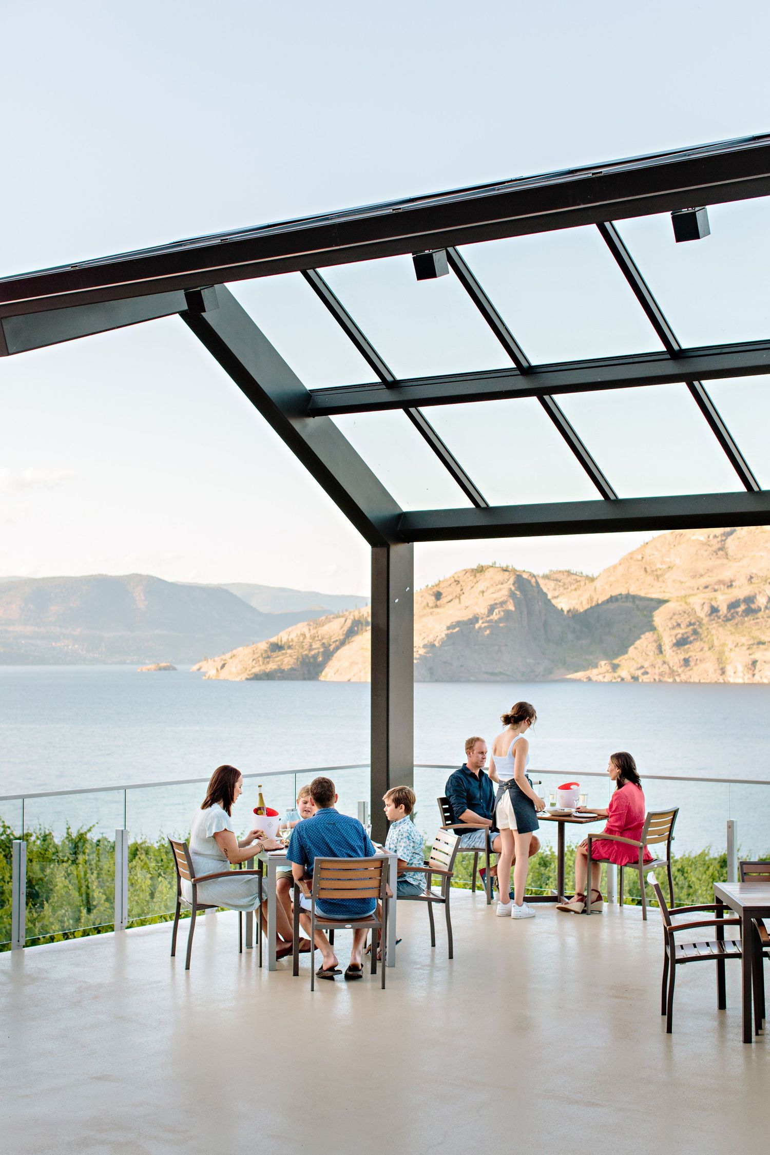 Covered outdoor patio dining area with stunning mountain lake views.