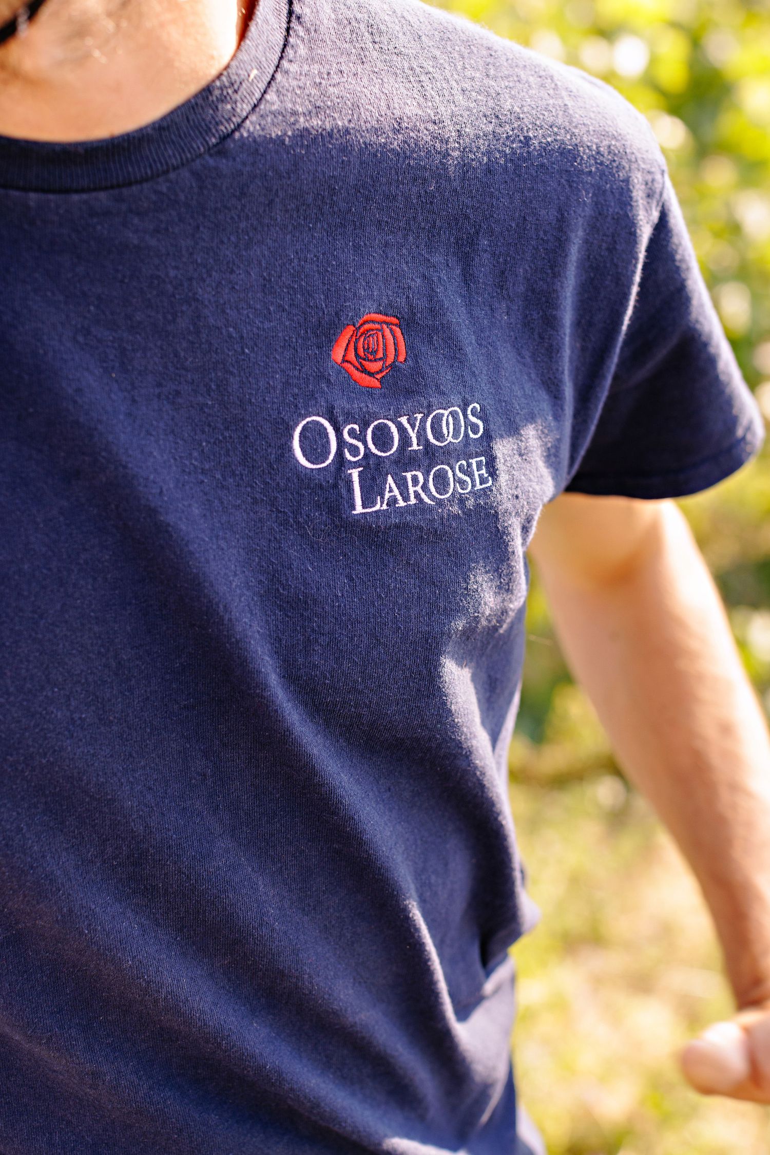Navy blue t-shirt with embroidered Osoyoos Larose logo and red rose emblem on the chest.