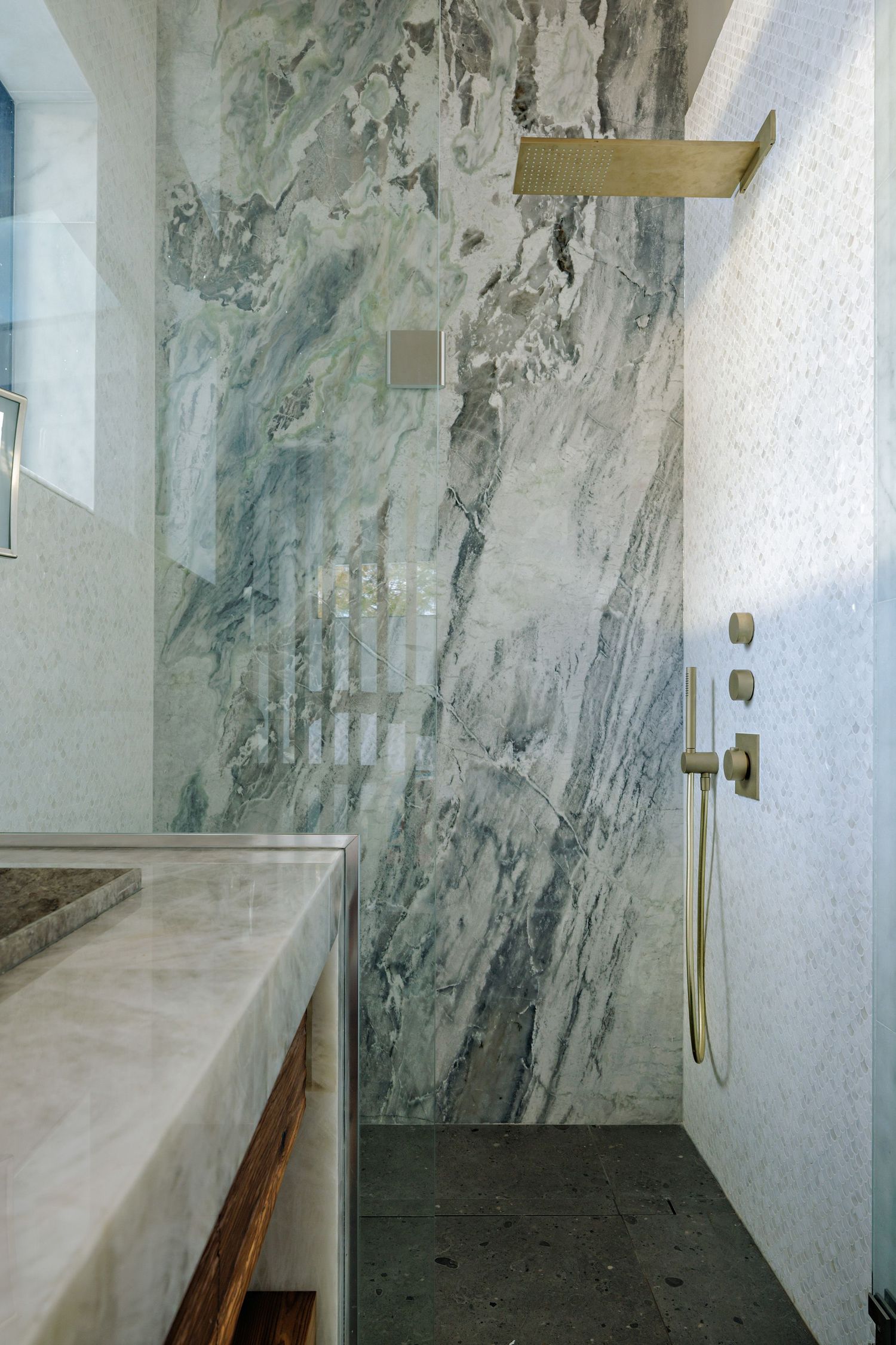 Modern bathroom interior with marble-effect walls and sleek floating vanity in minimalist design.