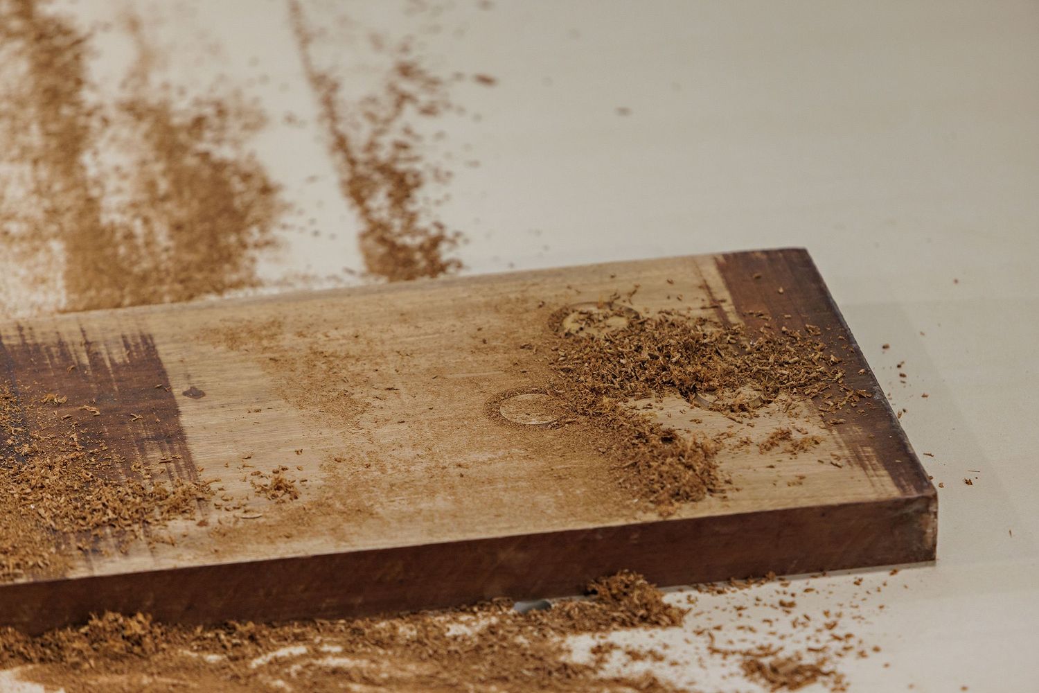 A series of wooden boards showing progressive stages of wood staining from light to dark brown finishes.