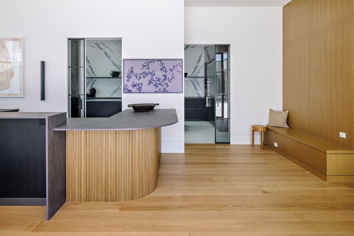 Modern interior hallway with wooden paneled walls and white flooring showcases minimalist architectural design.