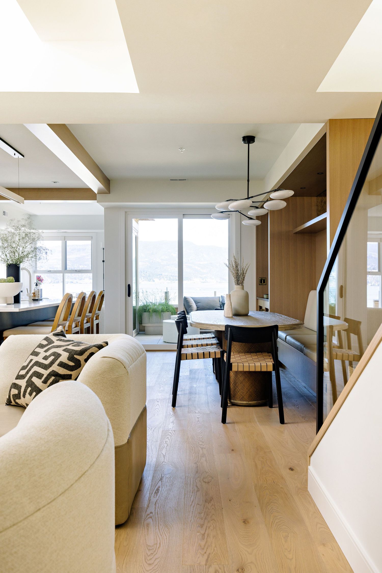 Open concept living space with hardwood floors, modern furniture, and large windows.