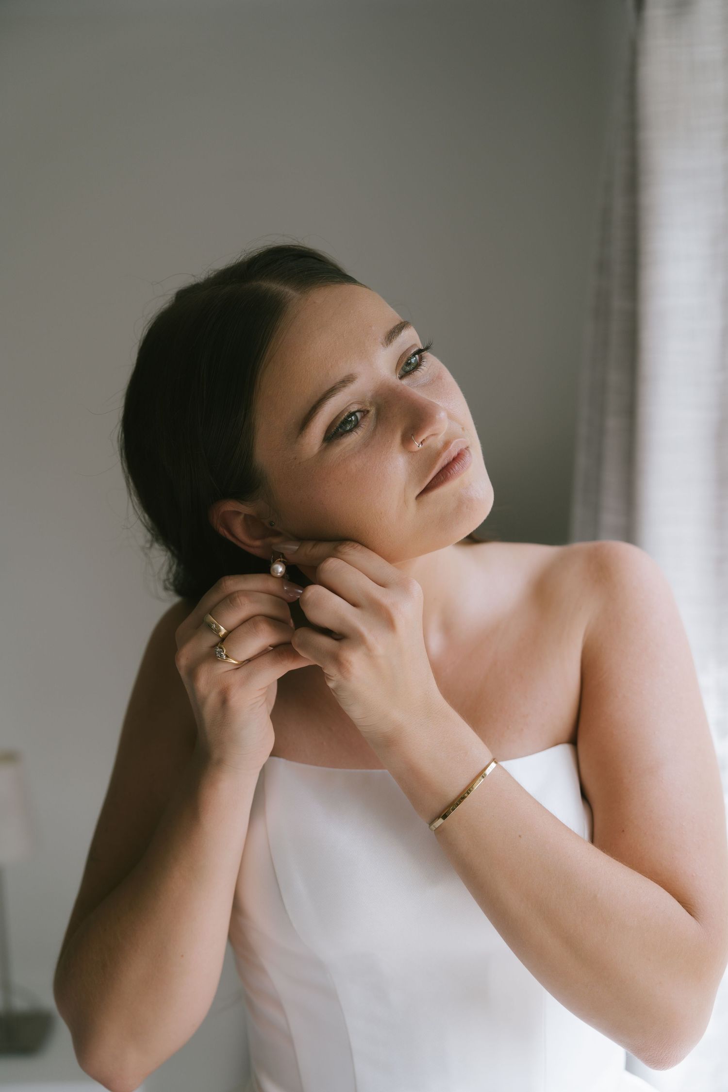 Close-up shot of wedding preparation with white dress and delicate details.