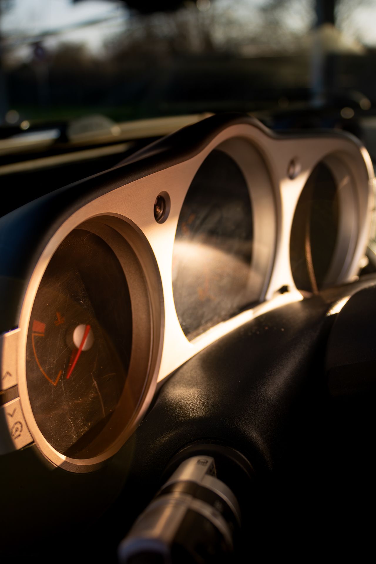 Close-up sequence of car dashboard gauges showing speed and RPM dials in dramatic lighting.