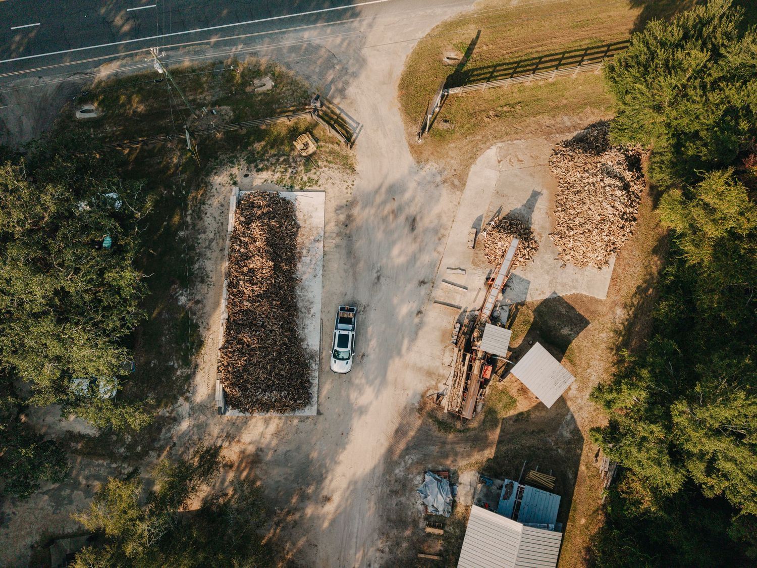 Aerial view of a rural property with dirt roads and scattered buildings.