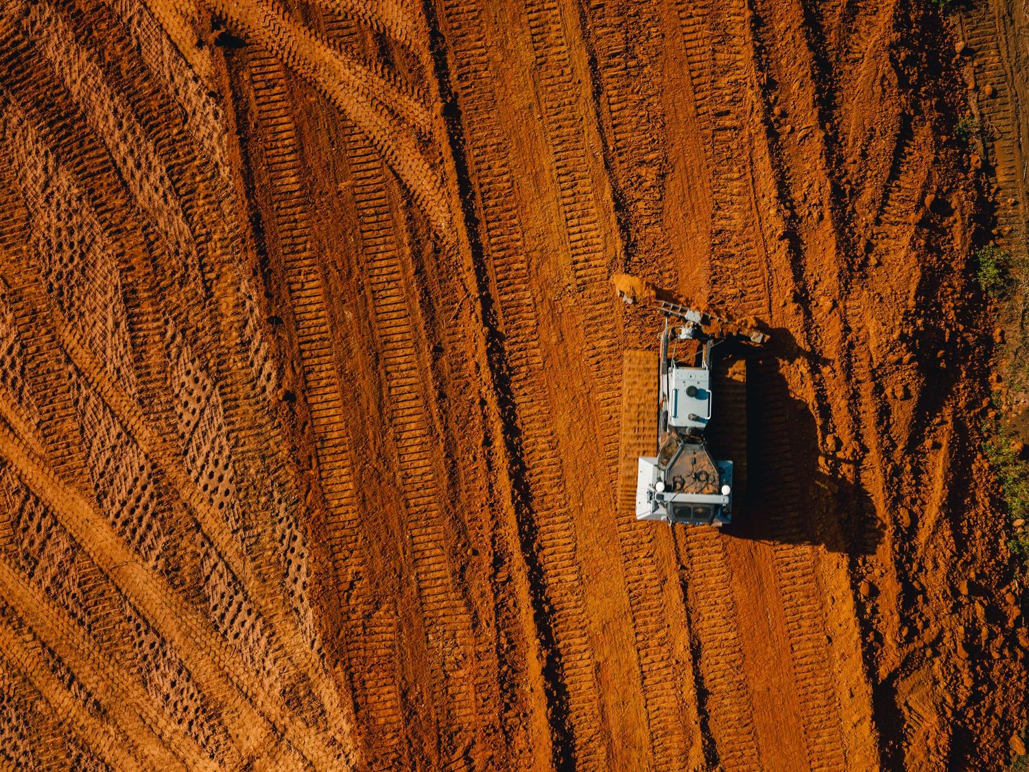 Mountain biker rides down steep orange sandstone cliffs in Moab, Utah during sunset.
