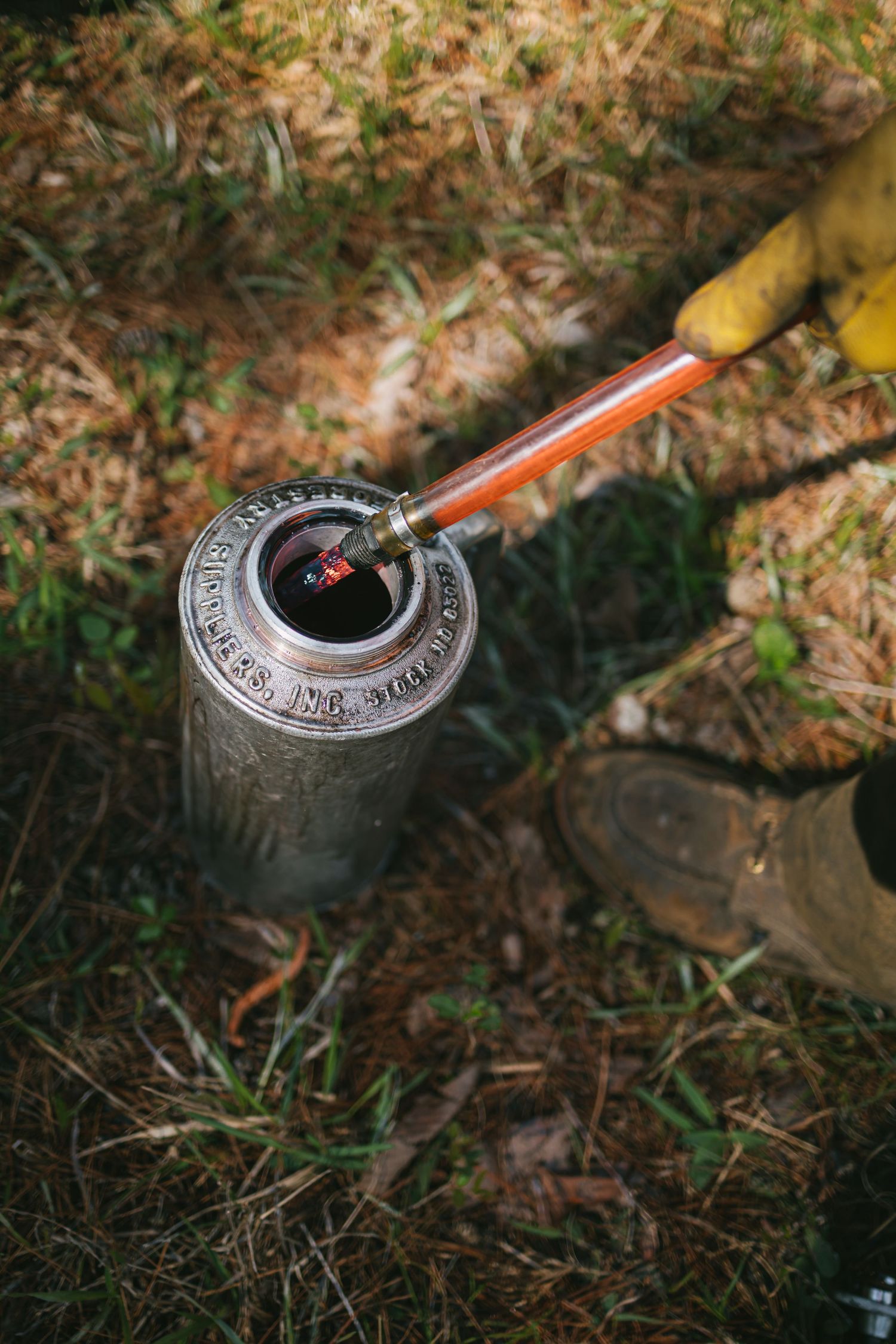 Close-up sequence of a compass being used for navigation on forest ground.