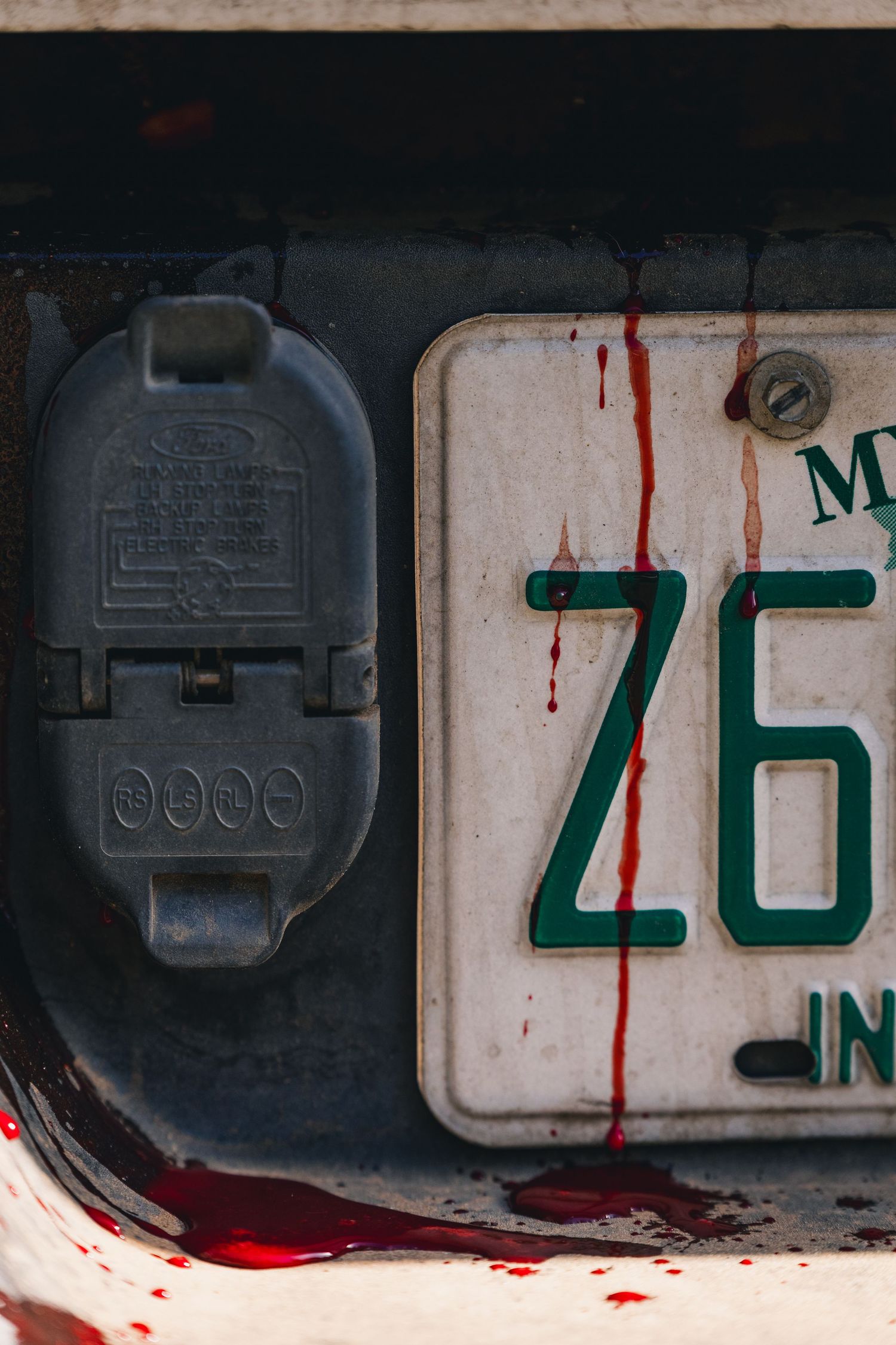 Numbered mailboxes with blood-like red stains dripping down.