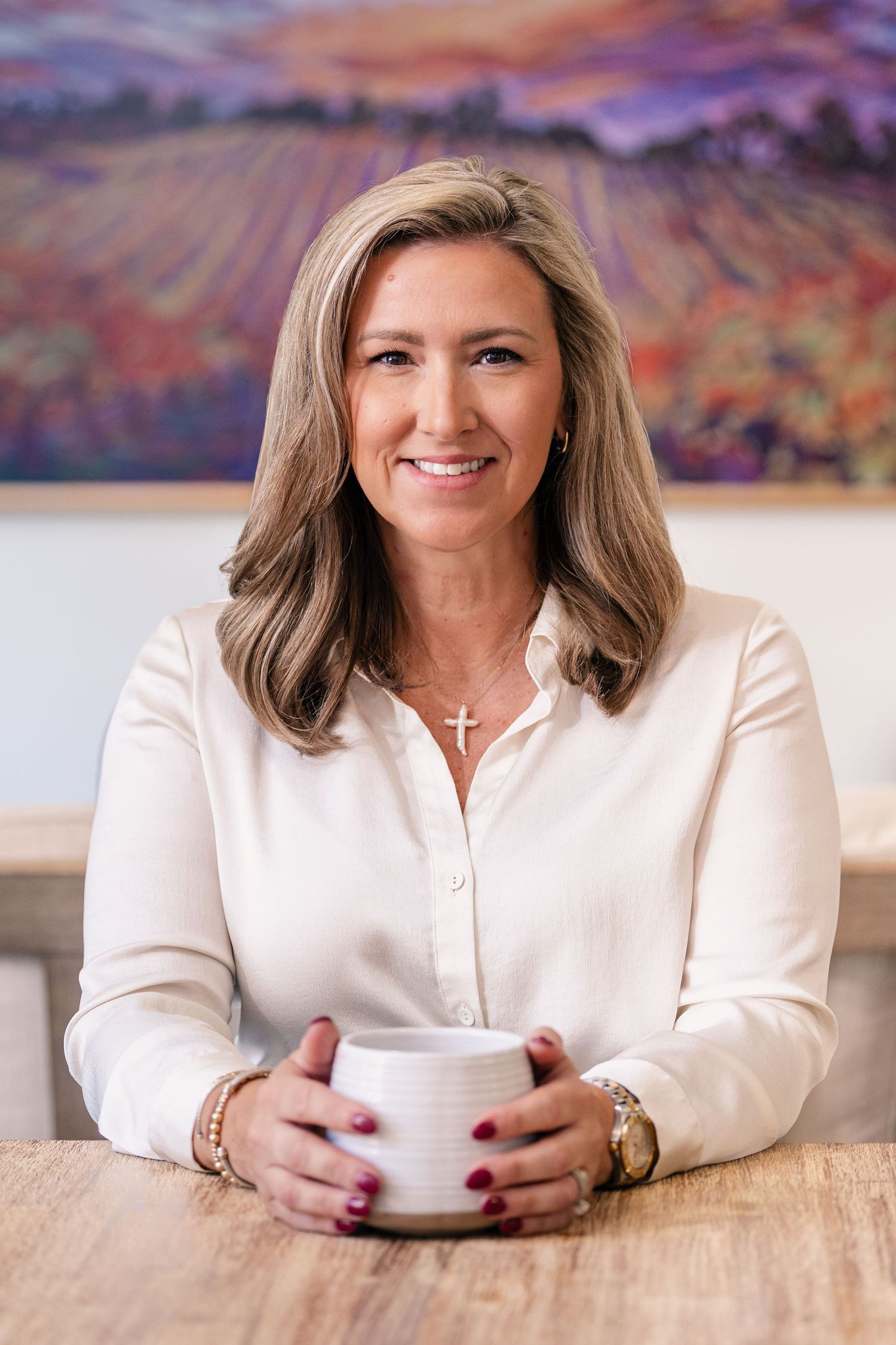 Professional portrait in cream colored setting with warm lighting.