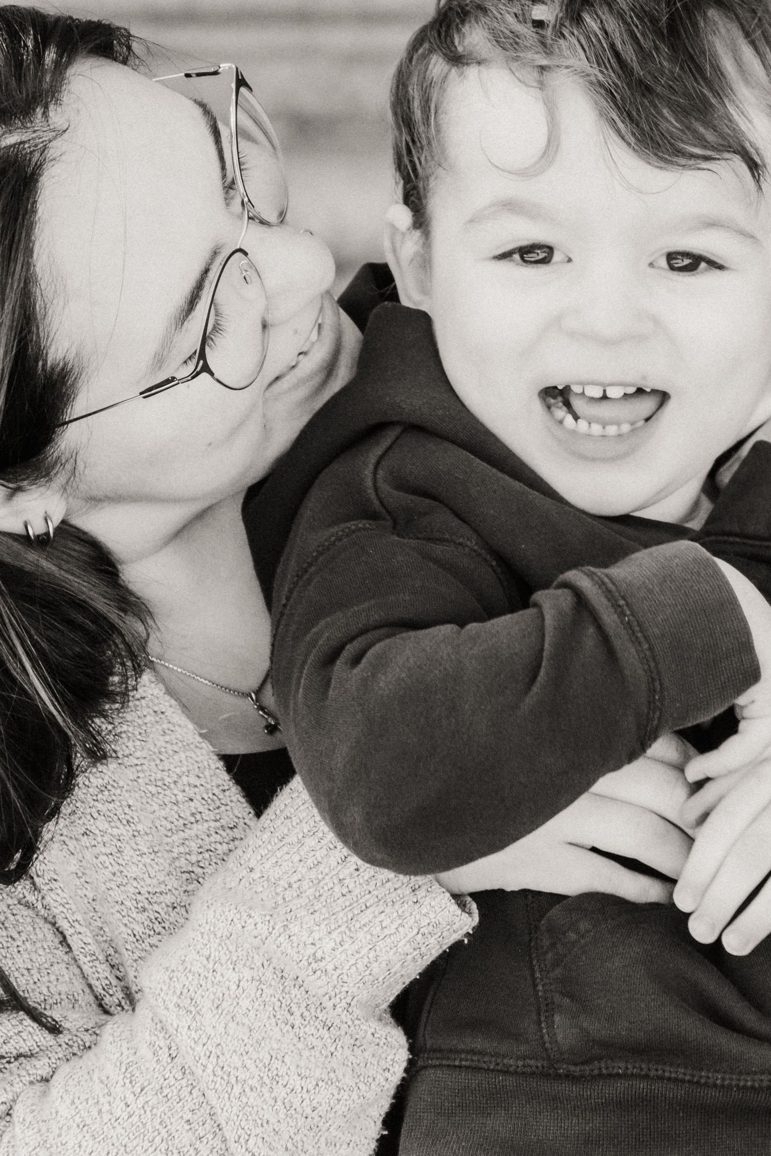 A series of black and white candid photos showing two children in a sweet embrace.