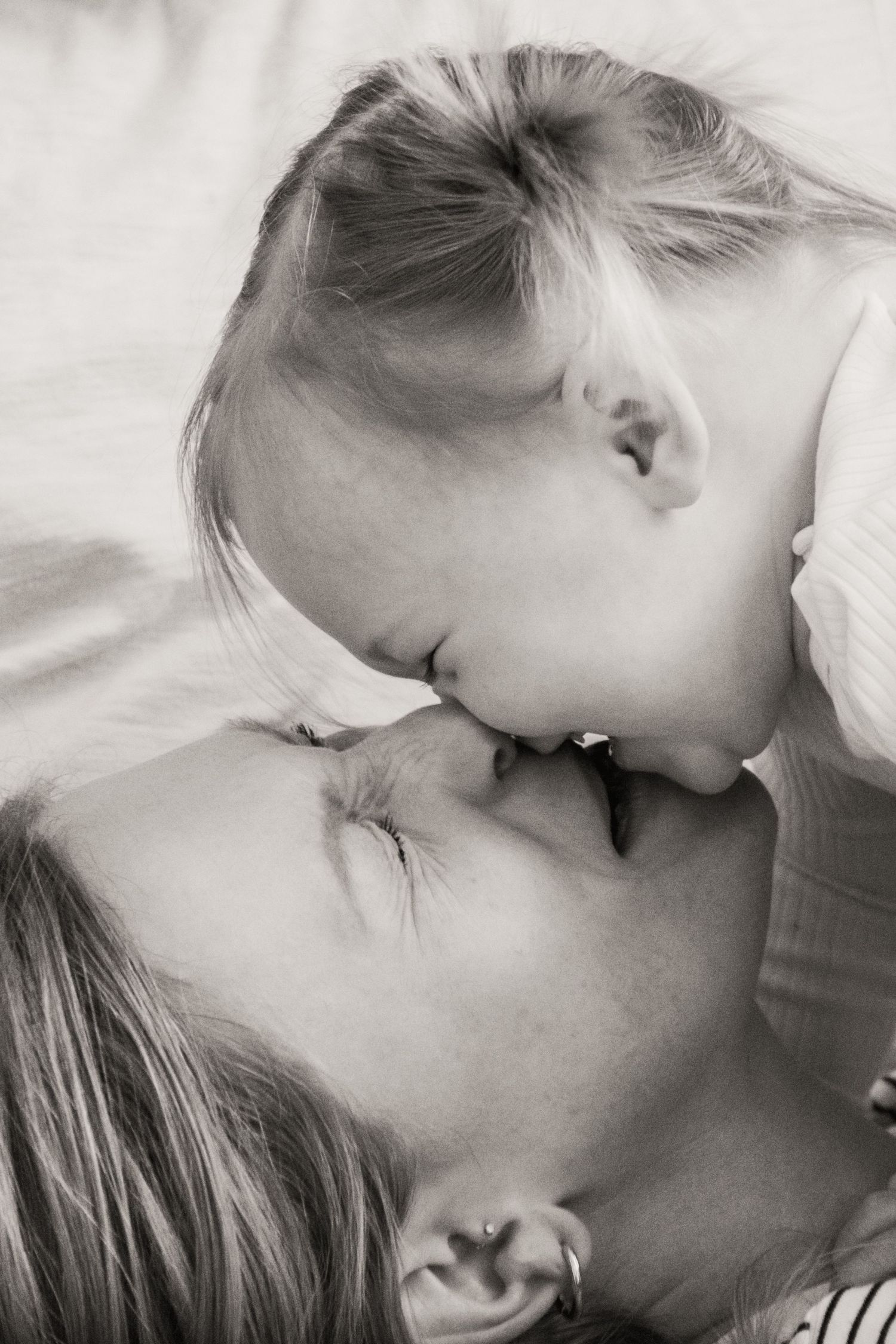 A black and white artistic photo series showing intimate tender moments between two people kissing.