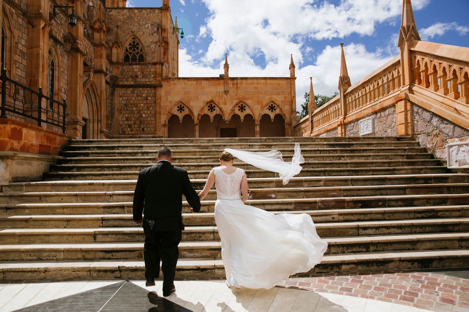 Couple walking up steps at their wedding in Mexico
