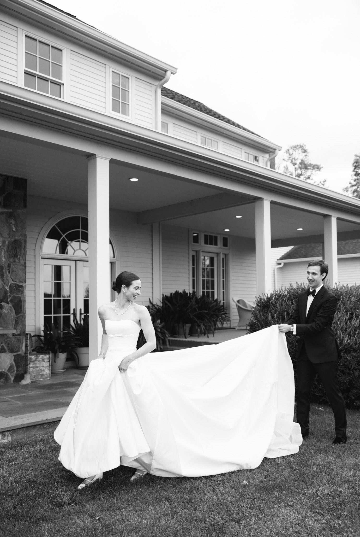 Groom carrying the bride's dress at LionRock Farm wedding