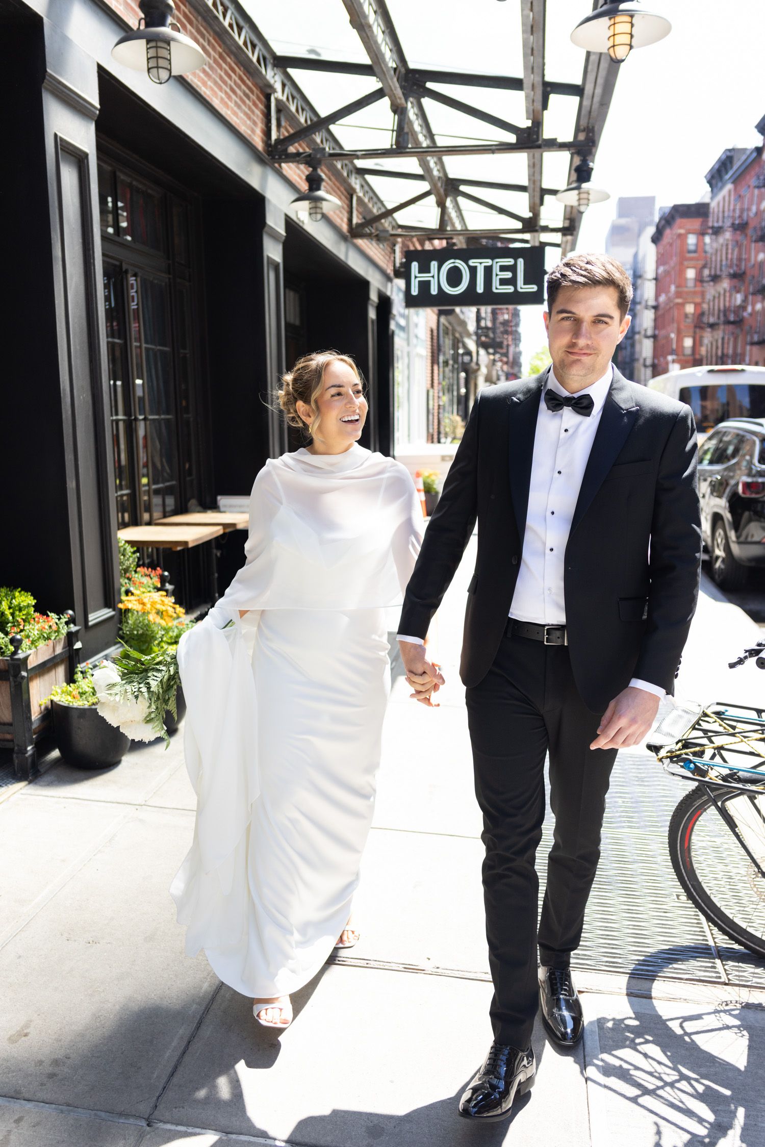 Couple walking down the street outside the Ludlow Hotel in NYC
