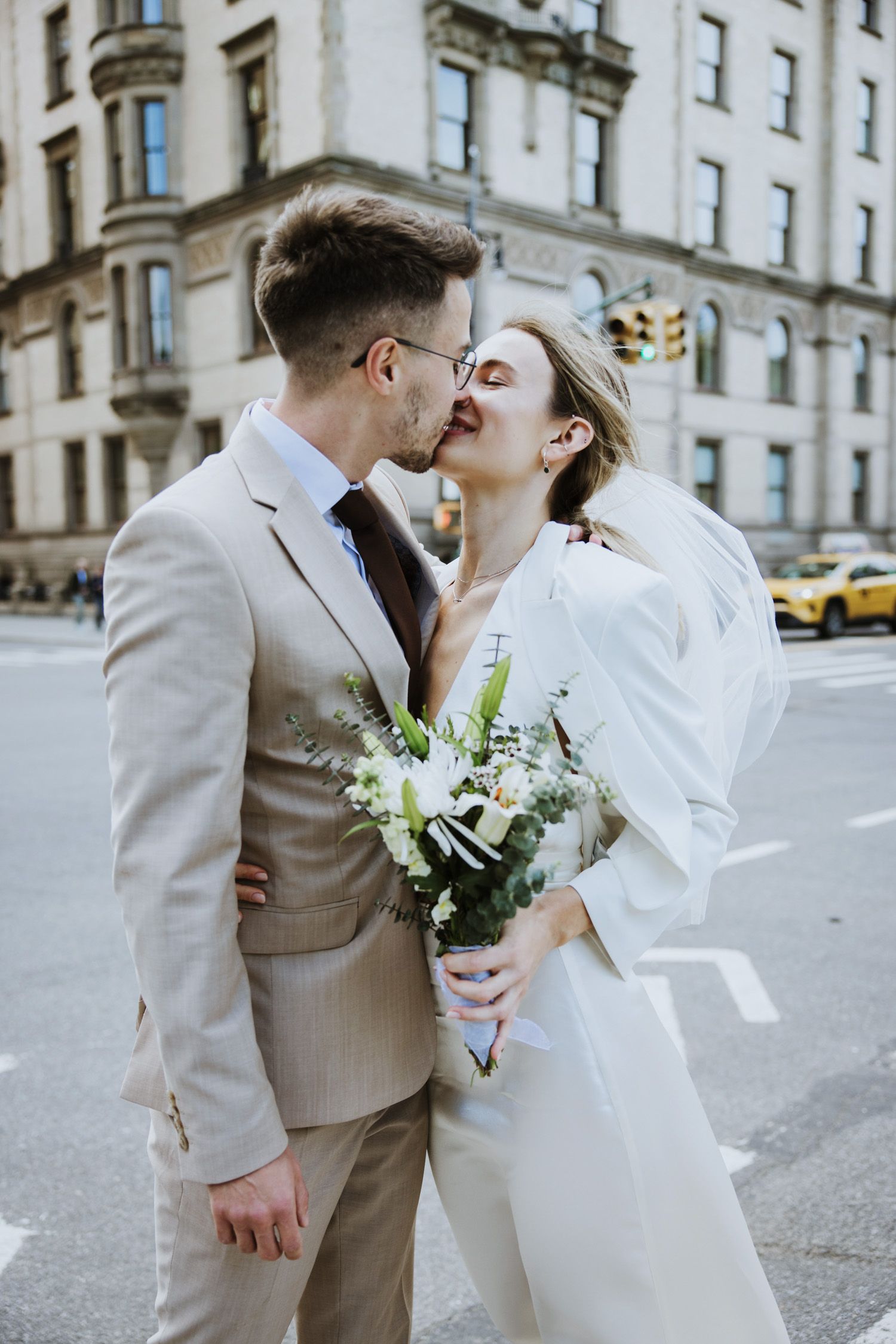 Couple kissing in the street near Central Park entrance in NYC