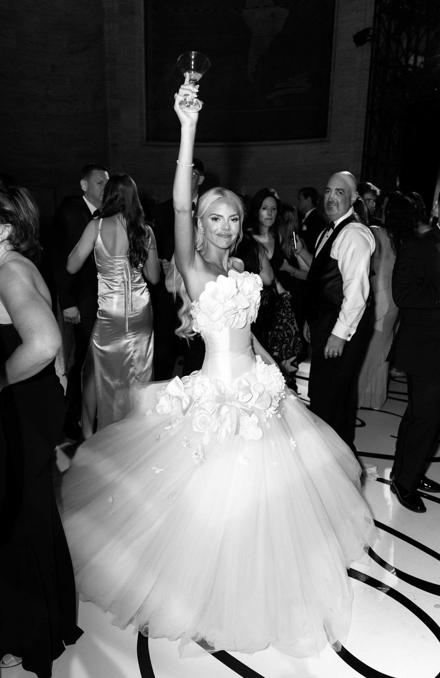 Bride holding up a drink on the dancefloor of her reception at Cipriani 25 in NYC