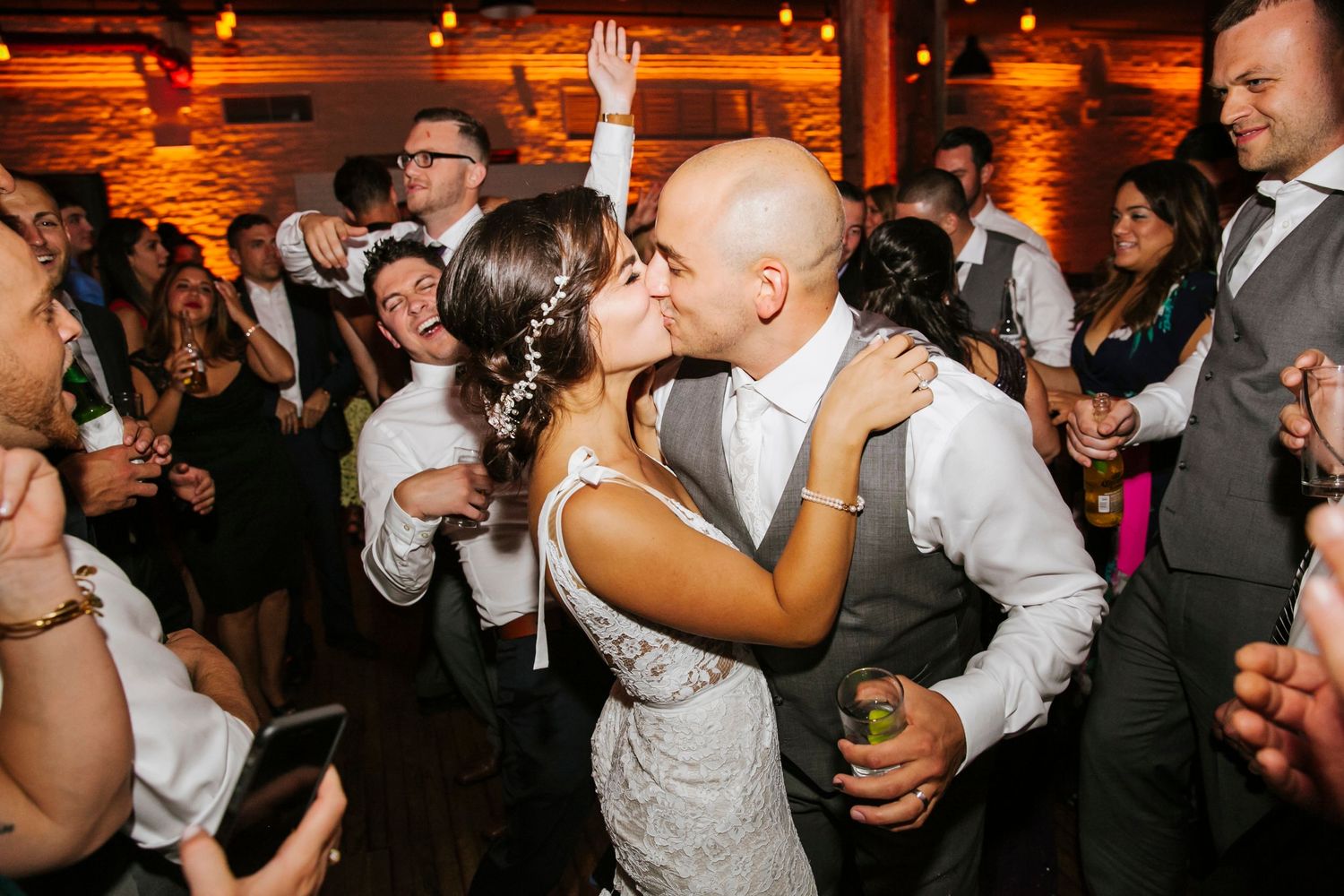Couple kissing at their wedding reception at Liberty Warehouse in Brooklyn, New York