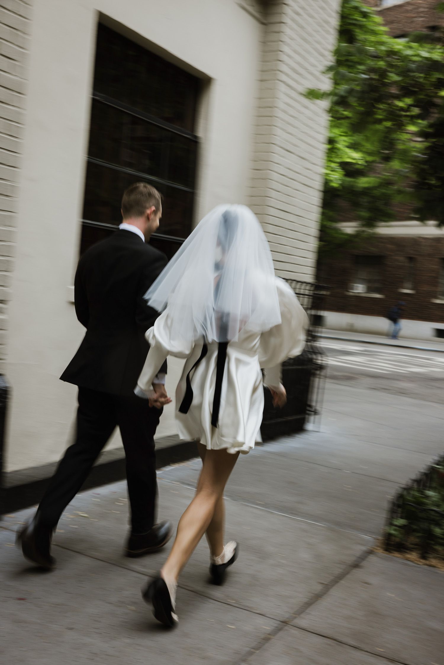 Couple running down the street outside Commerce Inn in NYC
