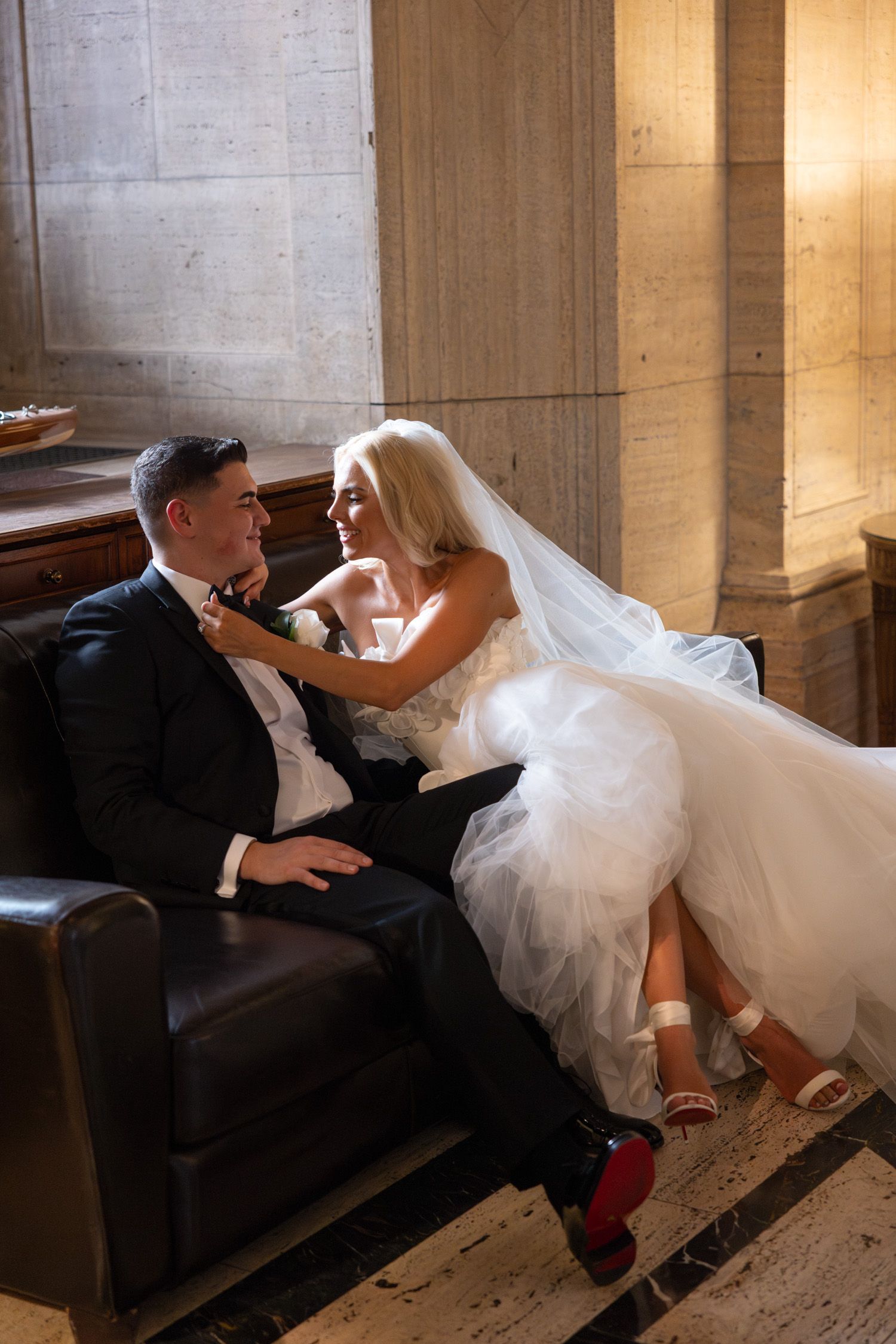 Bride fixing groom's bowtie at Cipriani 25 wedding in NYC
