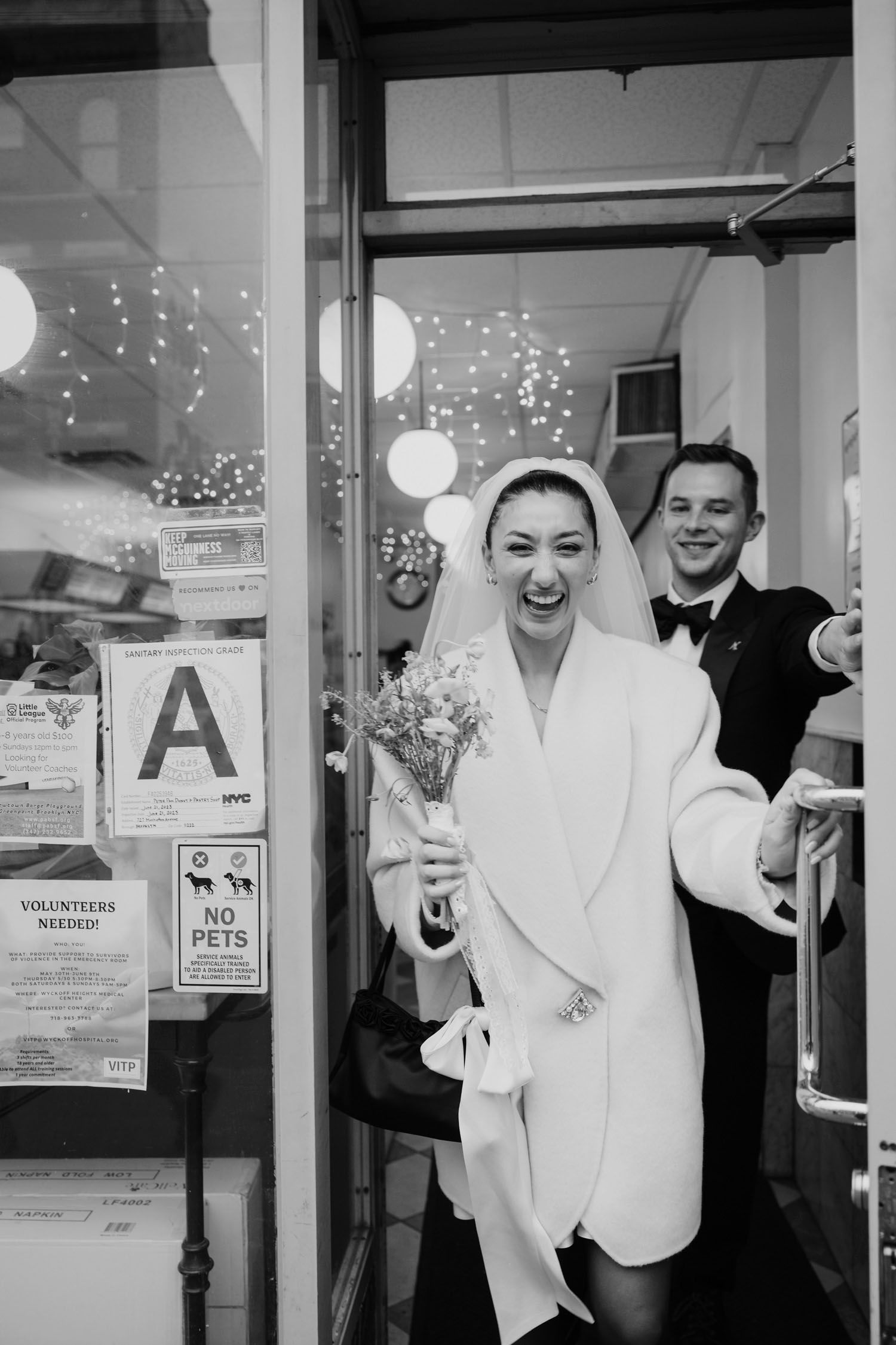 Couple leaving Peter Pan Donut & Pastry Shop in Greenpoint Brooklyn