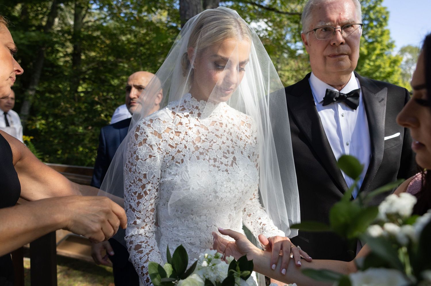 Bride fixing her veil before walking down aisle at Antrim Streamside wedding