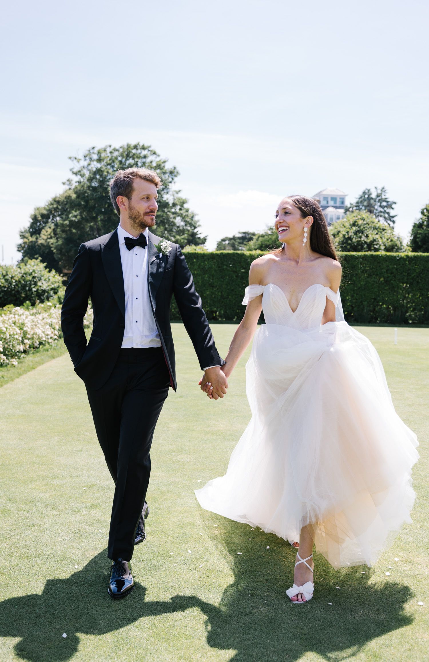 Couple holding hands and walking at Ocean House wedding in Rhode Island