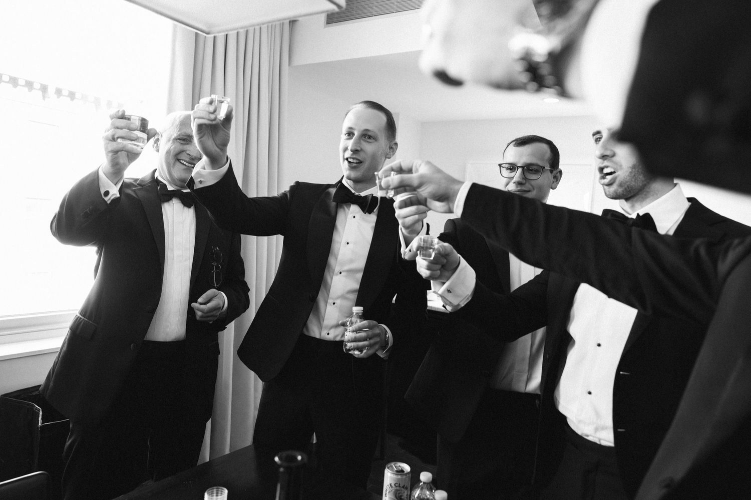 Groom and friends toasting before his wedding in NYC