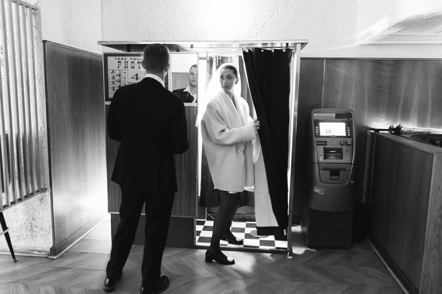 Couple entering a photo booth at a bar in Greenpoint Brooklyn