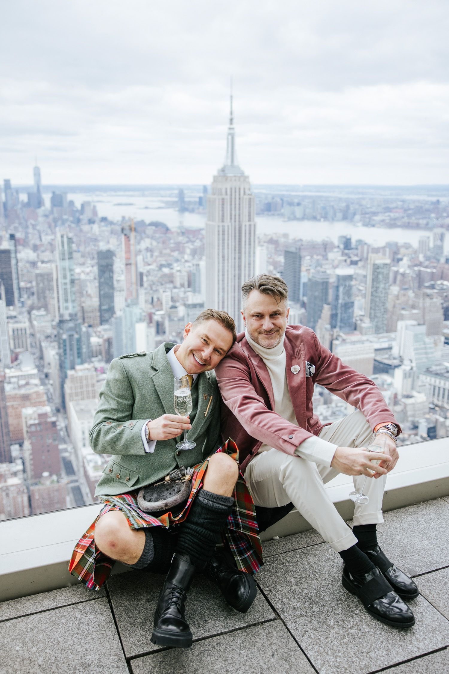 Couple drinking champagne on the top level of SUMMIT One Vanderbilt in NYC