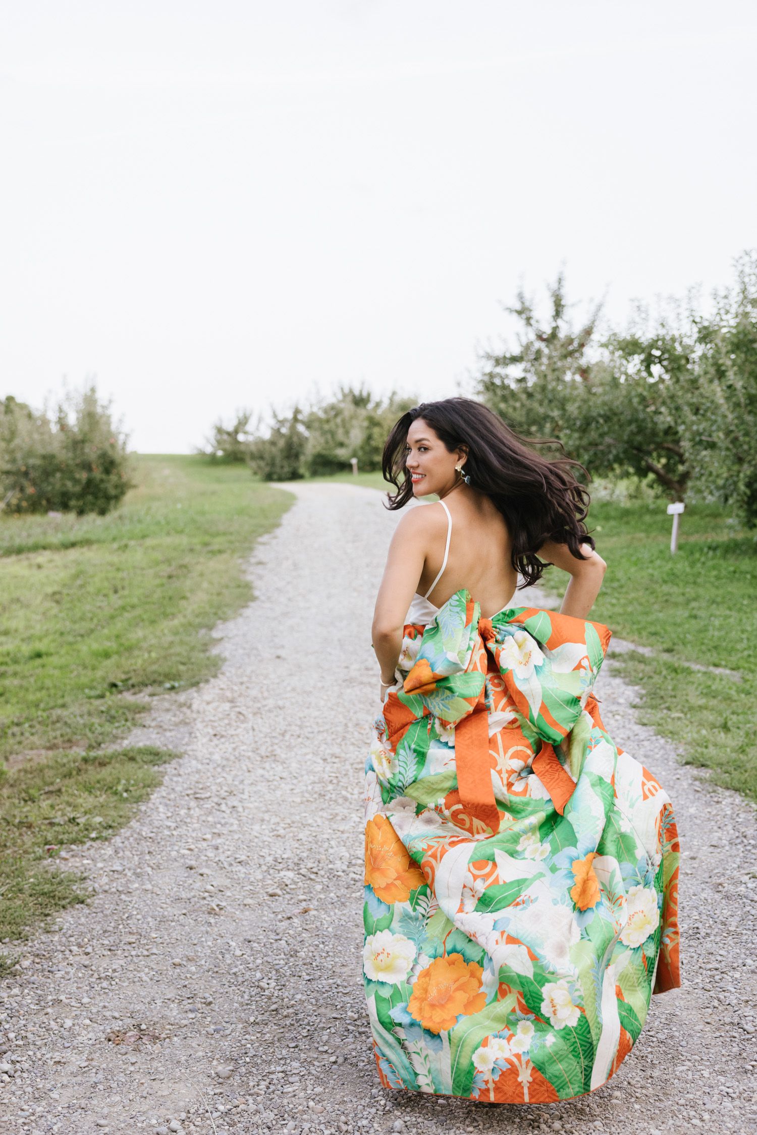 Bride running down the path at Rose Hill Farm wedding
