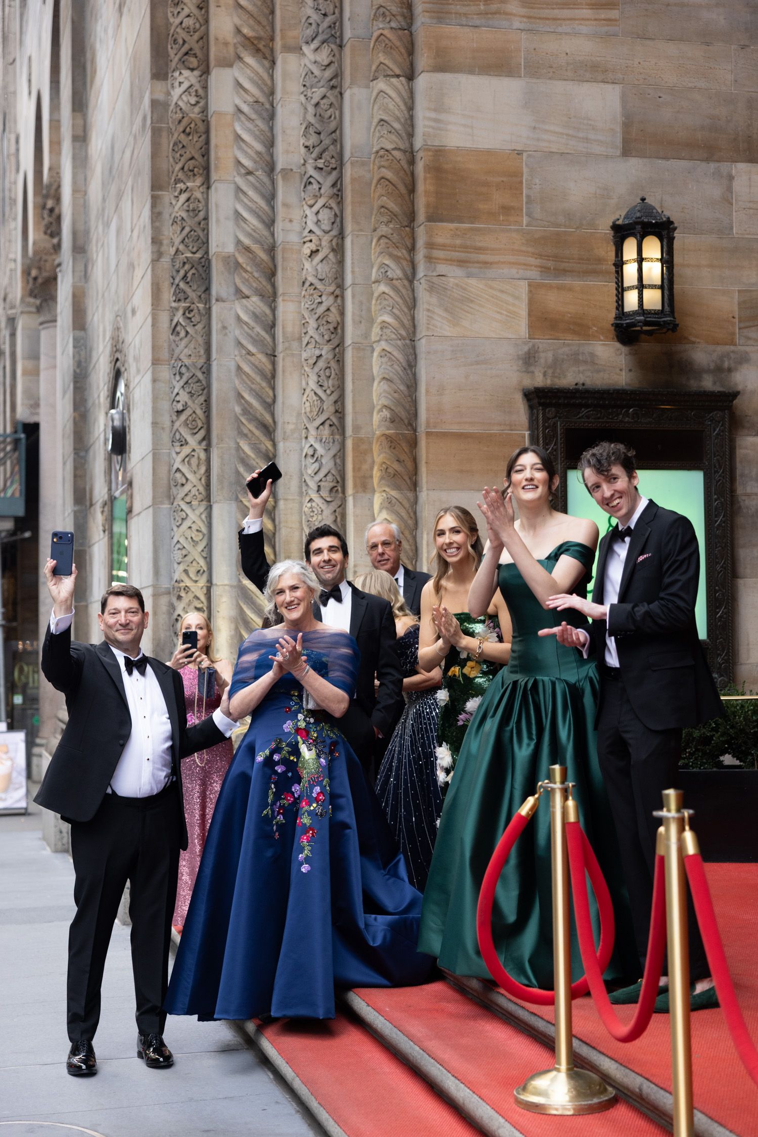 Family and friends cheering for the couple on the steps of Cipriani 42 in NYC