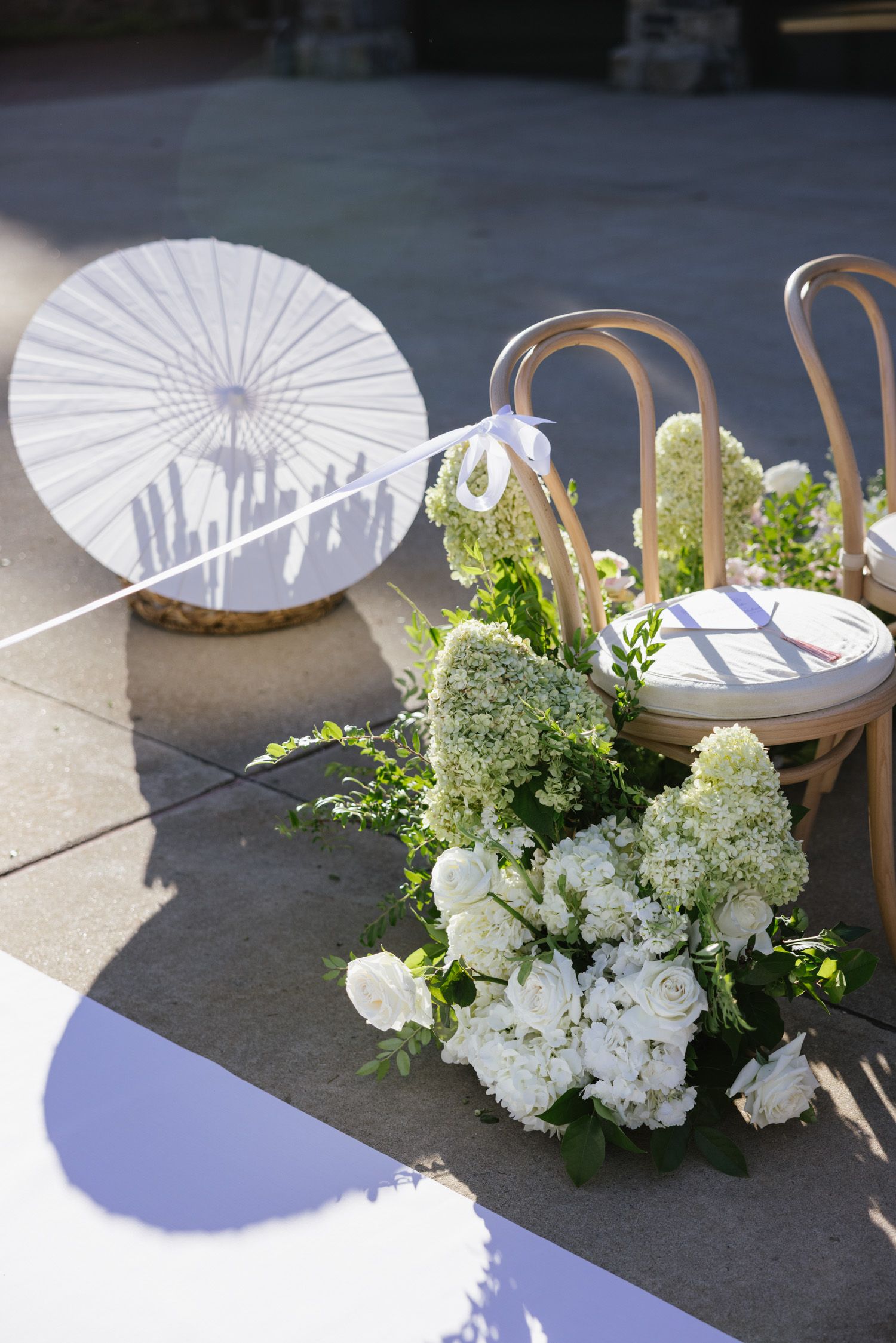 White parasol and floral arrangement at Blue Hill at Stone Barns wedding
