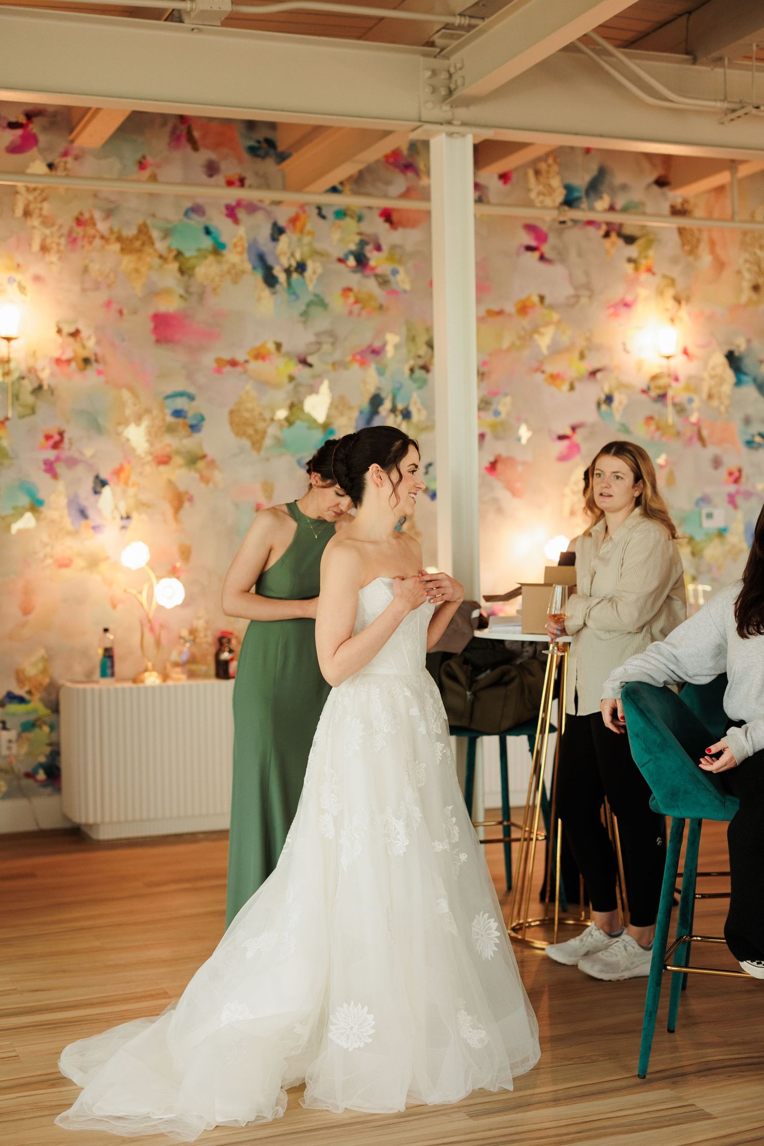 Wedding celebration in a room decorated with colorful paper butterflies and string lights.