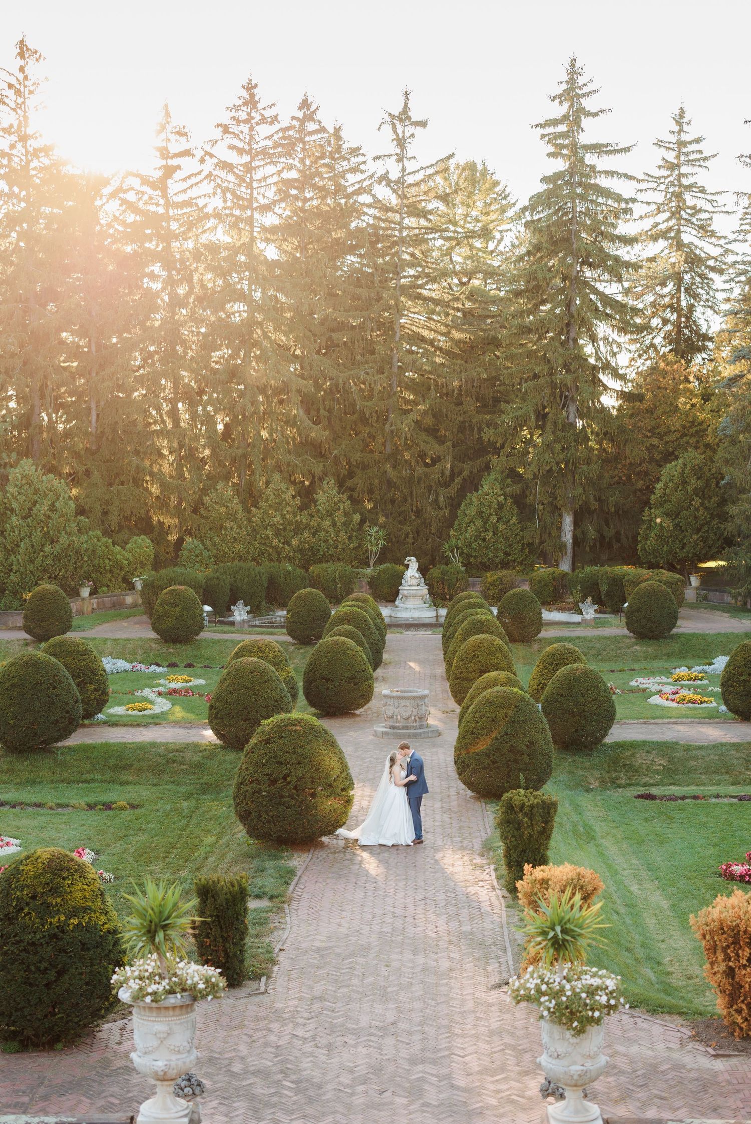 Aerial view of manicured garden path with perfectly trimmed topiary and evergreen trees.

Rochester NY wedding photographer