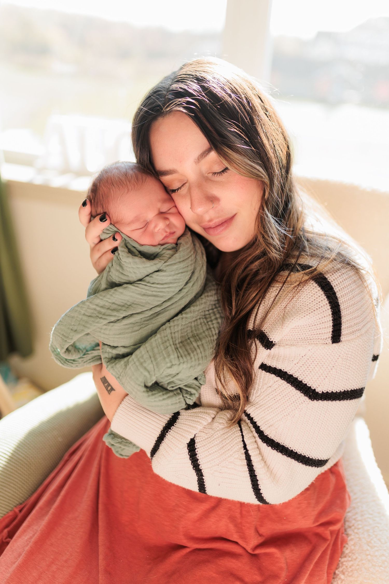 A tender moment between parent and newborn in soft natural light.

Rochester NY wedding photographer