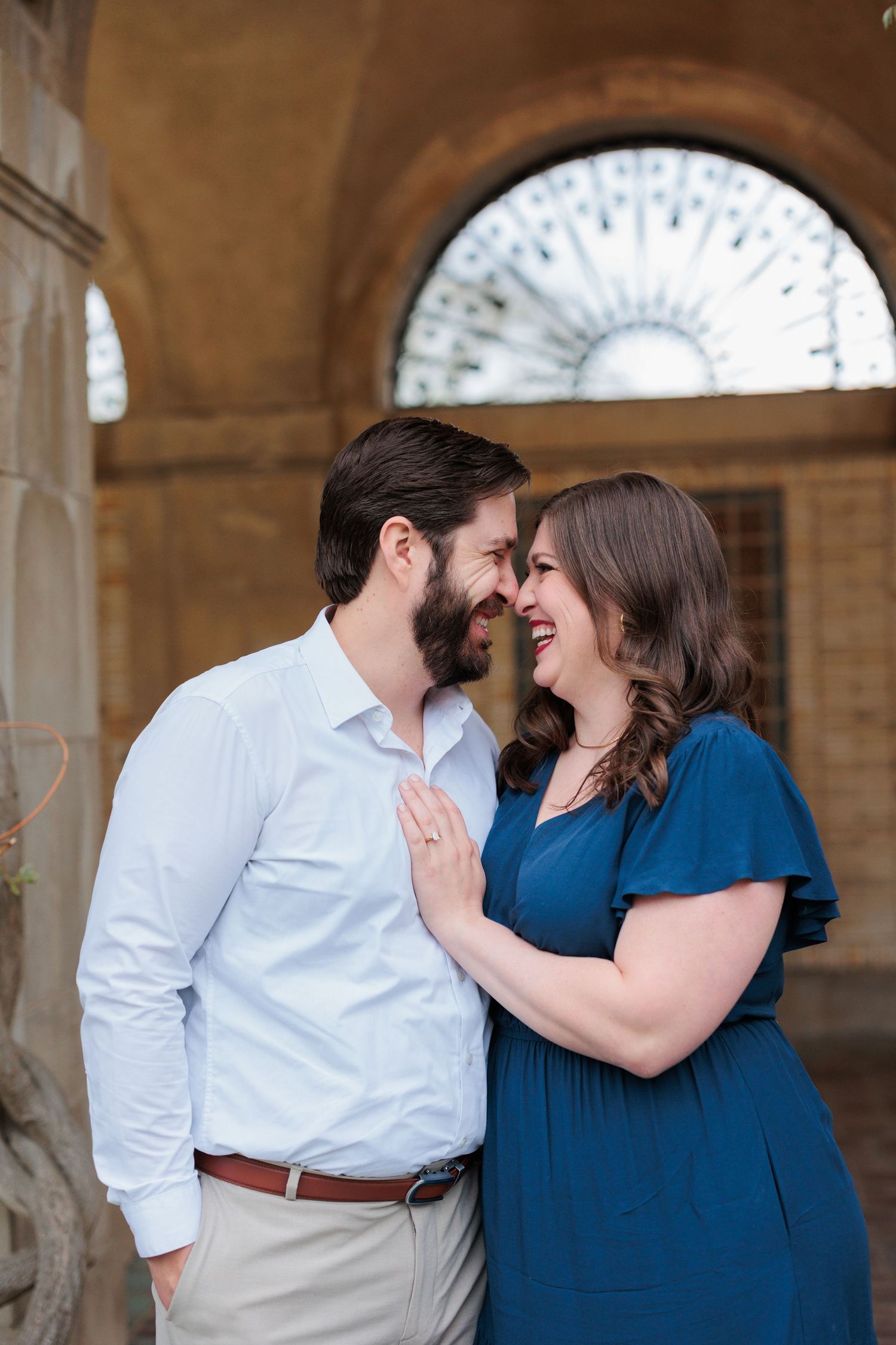 A tender moment shared under an ornate archway with decorative sunburst detail.
