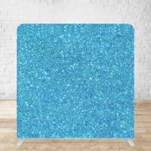 A glittering turquoise backdrop display with a sparkly aqua blue texture mounted on a wooden floor against a white wall.