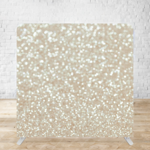 Glittering champagne-colored bokeh backdrop with sparkly light effects against a backlit photography background.