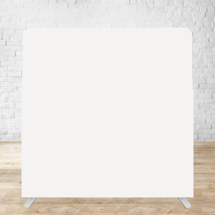 Empty white backdrop stand with wooden floor and brick wall background for photography or event displays.
