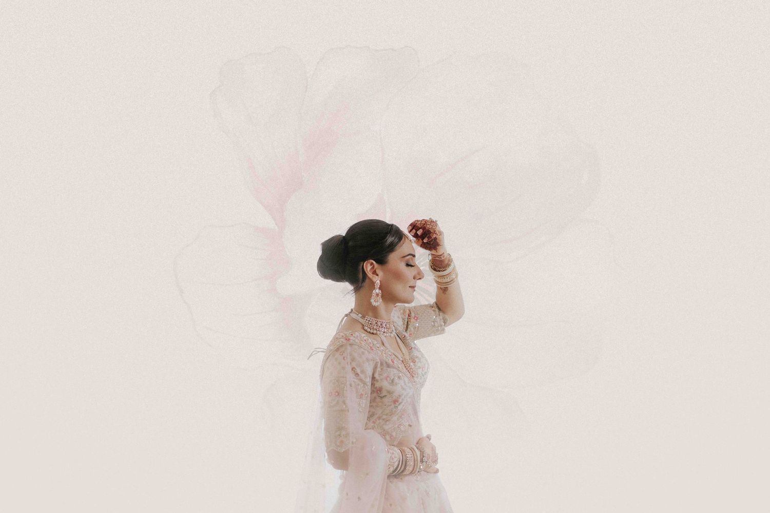 Ethereal side profile of bride in delicate veil against light background.
