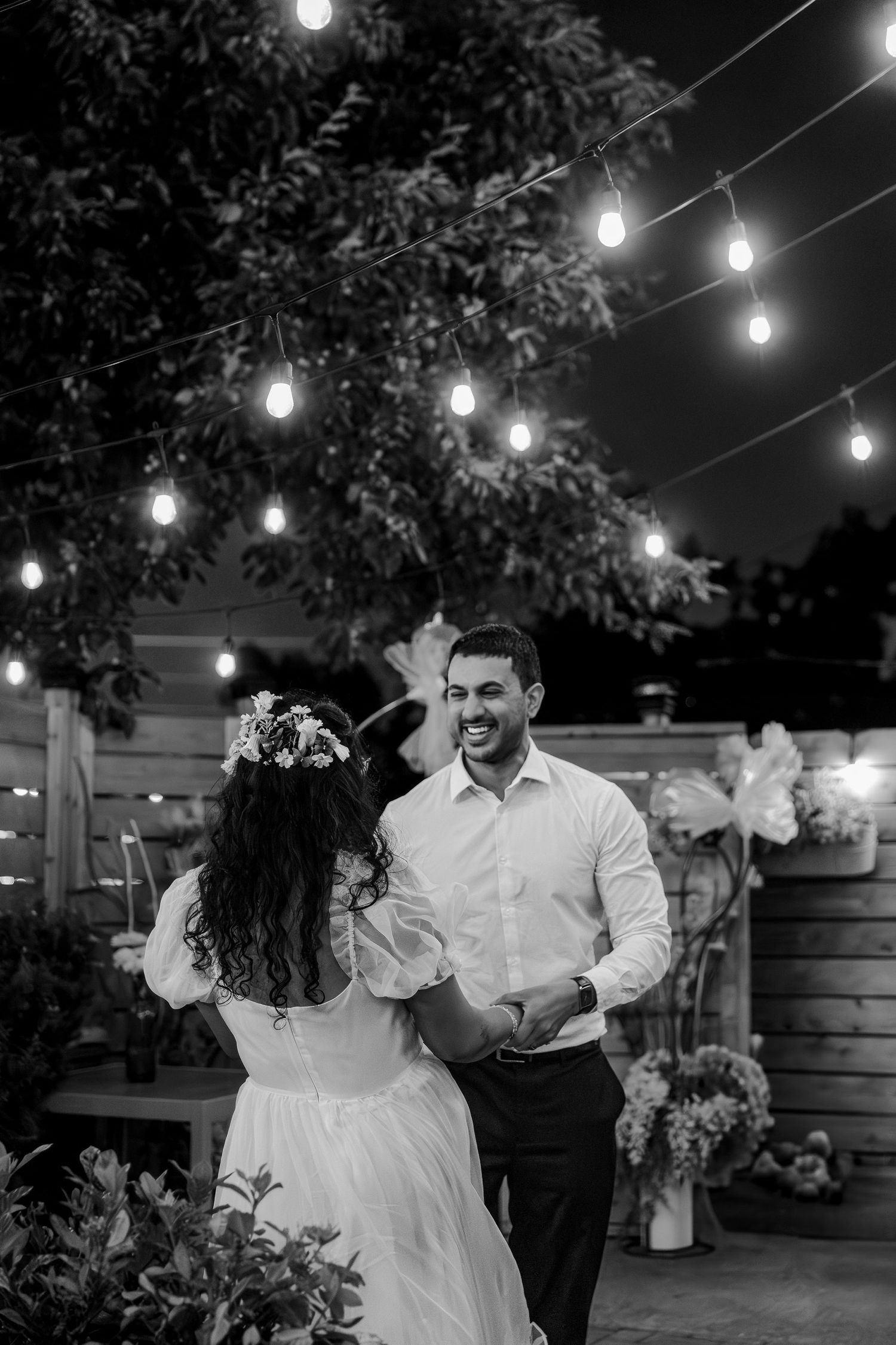 Bride and groom share their first dance under string lights at the Wilcox Gastropub in Mississauga, Ontario.