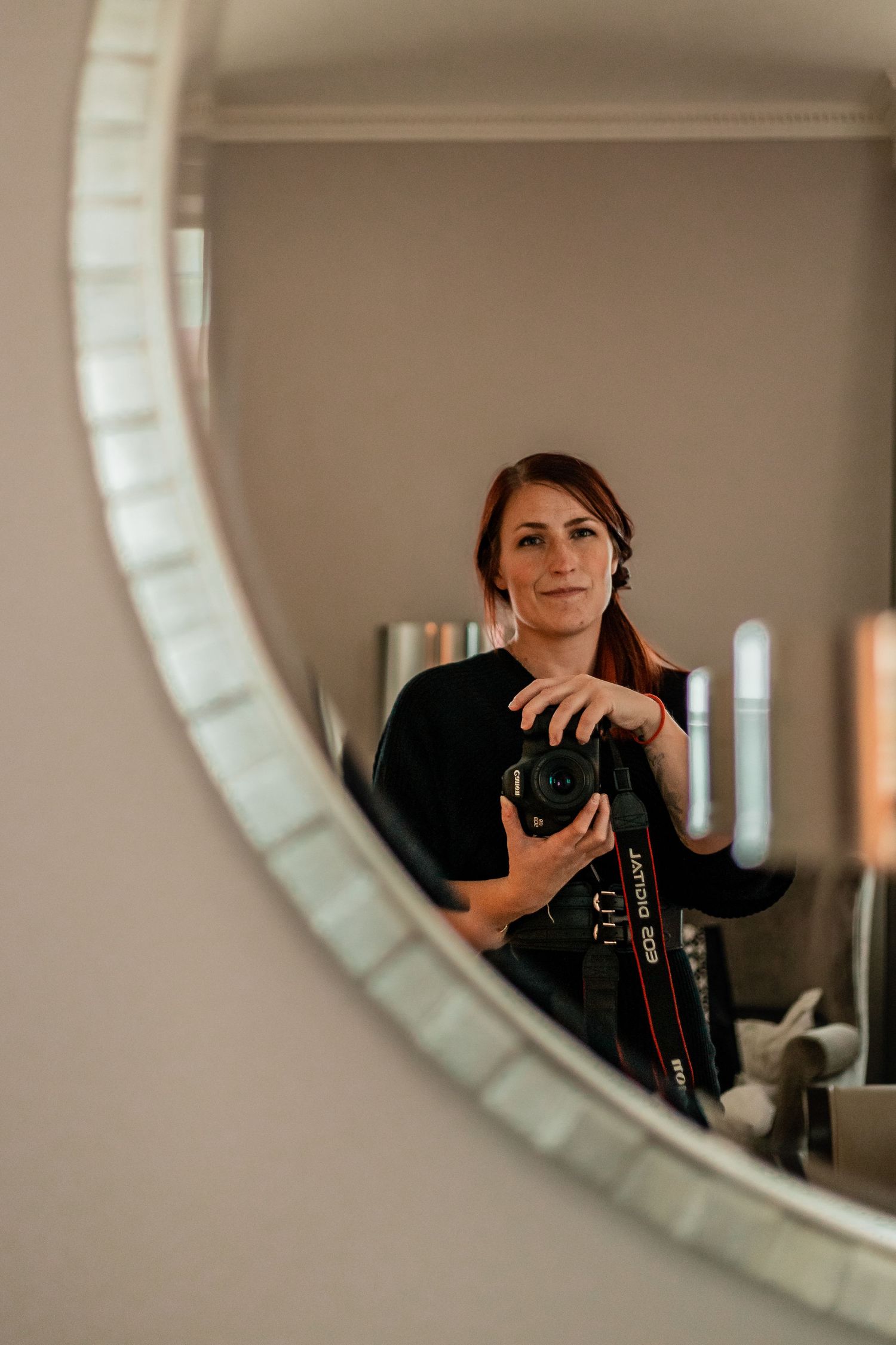 A picture of Jacquie in front of a mirror, the wedding and engagement photographer at Blush West Photography