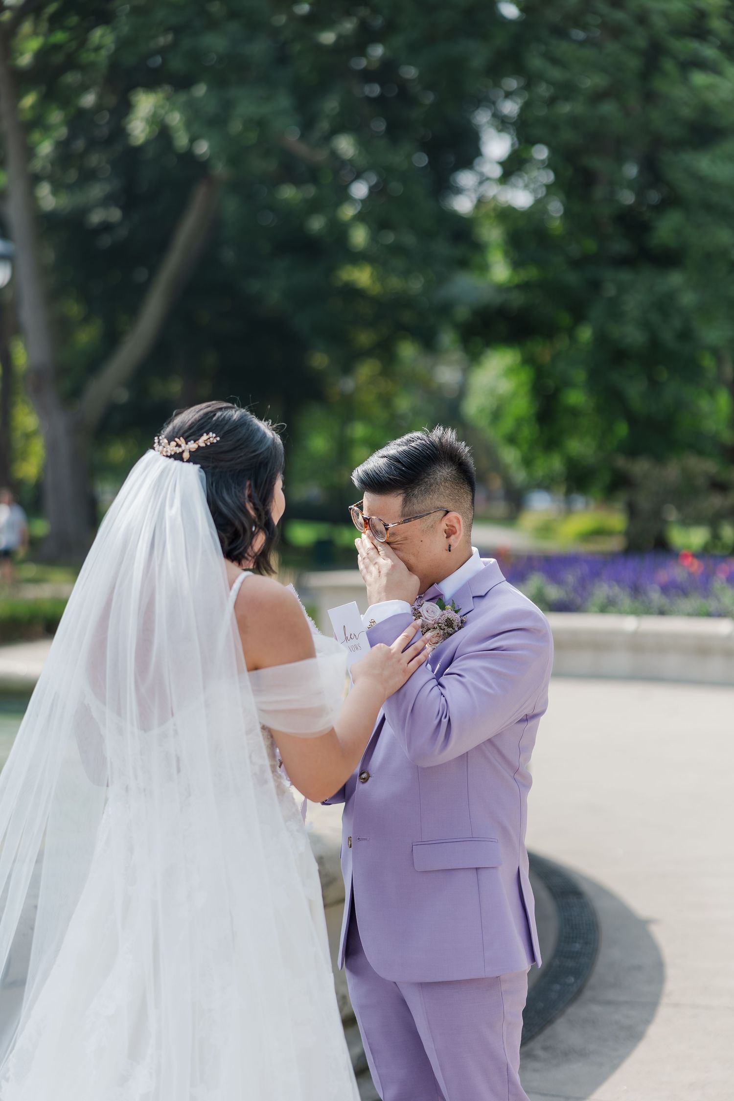 Candid wedding photo of groom crying during their private vow reading in front of the waterfall at gage park in hamilton, ontario.